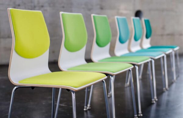 wood veneer chair of many colors in a line in greens and blues