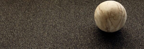 Close up photo of a spherical sculpture resting on Passages carpeting.
