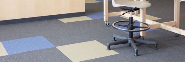 Studio shot of Accelerate flooring. There is a mix of color in the carpet pieces.