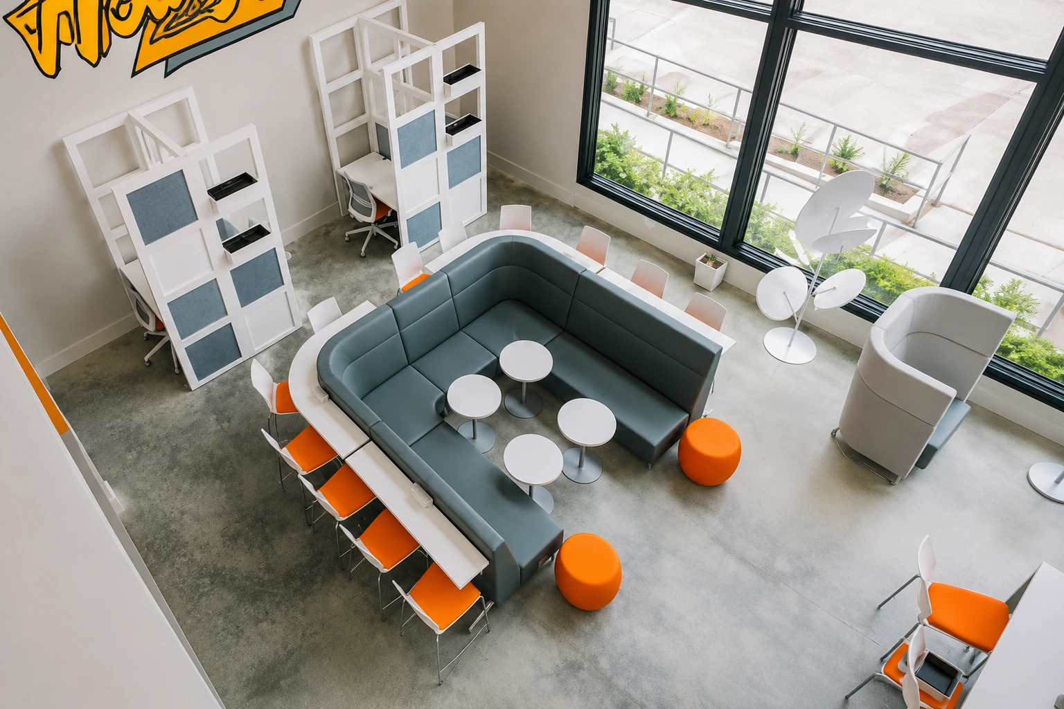 Open office workstations with height-adjustable desks and orange task chairs beneath a wood slat ceiling